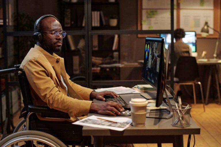 man in a wheelchair on a computer