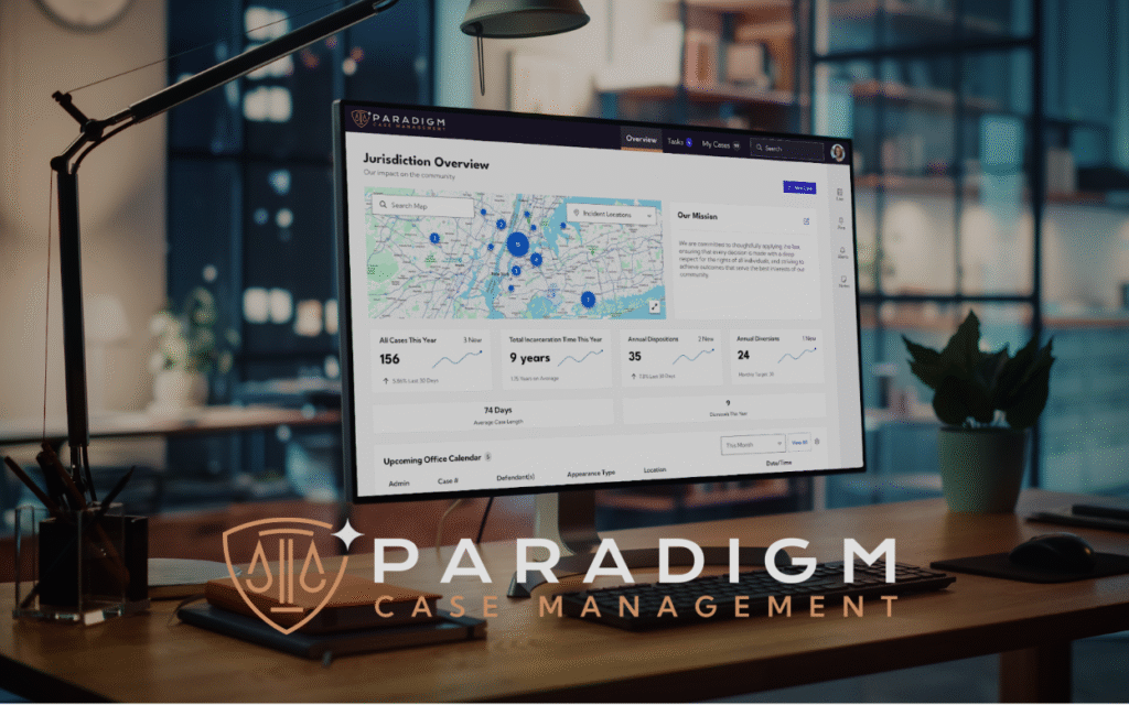 Paradigm Case Management header image showing a desktop computer on a wooden table with the jurisdiction overview dashboard